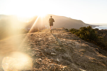 Running man on mountain and sunrize background