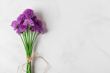 Purple alium flowers bouquet on white background with copy space. top view. flat lay. wedding or holiday concept