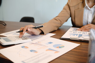 Calculating Cost Economic budget saving and investment concept.analyzing investment charts and calculator Accounting