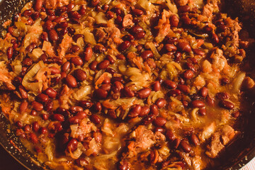 Food ingridients: meat, onion, ginger for recipe stewed beans with meat frying in a pen on a stove. Steps in cooking, process of preparing food. Concept of homemade healthy food.