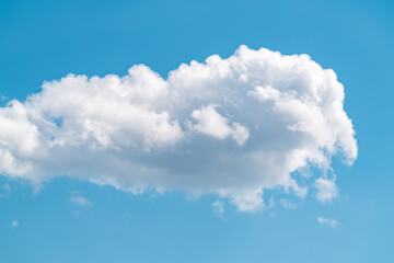 Naklejka na ściany i meble One fluffy cloud on blue sky