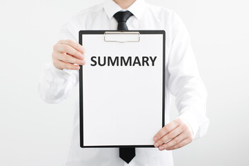Summary text on a tablet in the hands of a businessman on a gray background