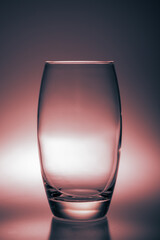 Teal and orange colored concept art with a drinking glass in a studio being photographed in a different way and with unusual focus points as normal. 