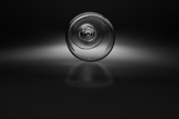 Black and white concept art with a wine glass in a studio being photographed in a different way and with unusual focus points as normal. 