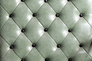 close up green retro leather sofa upholstery background and texture