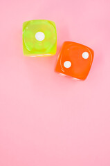 two dice on a pink background - top view