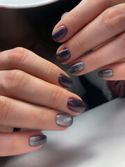 The work of a manicure master. Hands of a beautiful young woman and modern design.