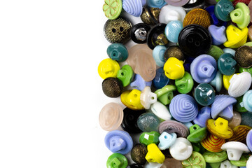 Colorful bright buttons on a white background. Old vintage buttons close-up. Copy space. Top view. Background of buttons. Flat lay.