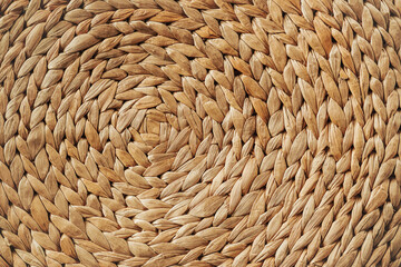 Woven rattan. Weaving circle pattern background. Detail and texture of traditional handicraft. Natural basketry material.