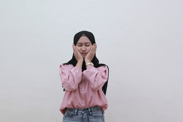 Young Muslim women put on cute faces in front of the camera on white background. Beautiful asian woman with casual dress. Beautiful muslim women.