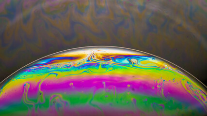 Fluid soap bubble looking like planets. Psychedelic colorful abstract art with urreal patterns of...