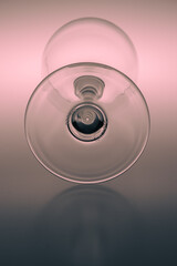 Teal and orange colored concept art with a wine glass in a studio being photographed in a different way and with unusual focus points as normal. 