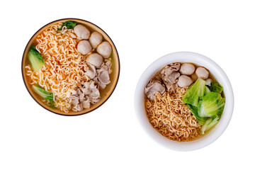 Two bowls instant noodles, Chinese cabbage, pork, pork meatballs in a ceramic bowl on a white wooden floor, top view. with clipping path.