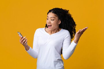 Mobile Offer. Surprised Black Woman Looking At Smartphone Screen, Exclaiming With Excitement