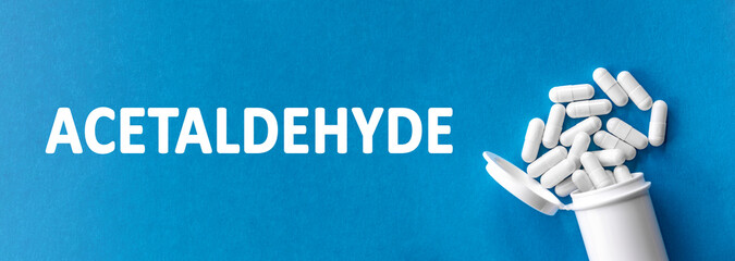 The word ACETALDEHYDE is written near pills on a light blue background. Medical, health and happiness concept.