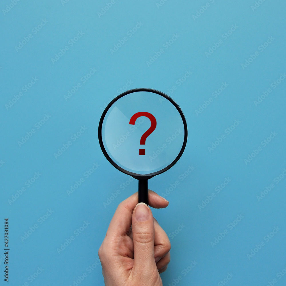 Poster a person examines a question mark under a magnifying glass. the emergence of questions and the searc