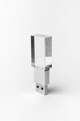 Glass transparent USB drive with metal insert isolated on grey background. Layout. Copy space. A high resolution.