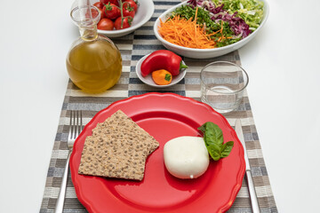 Nutritious dishes prepared with mozzarella salad and tomatoes. Natural and healthy ingredients of the Mediterranean diet: olive oil, cereals, peppers, vegetables, fruit and cheese. Farmers products