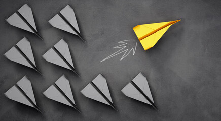 
Group of paper airplanes with yellow leader plane