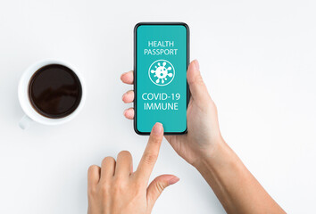 Lady holding smartphone with Immune digital passport for covid-19