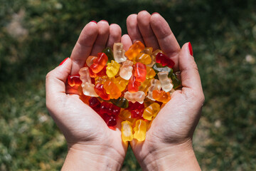 colored candies on hands