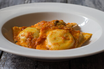 Homemade ravioli stuffed with borage and potatoes dressed with vegetarian ragout