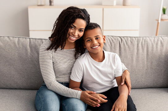 Portrait Of Black Mother And Son Hugging