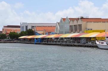 Fototapeta na wymiar View across the Waaigat in downtown Willemstad towards the colorful outdoor market stalls, Curacao