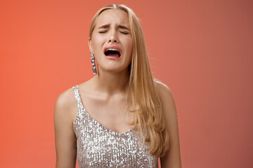 Immature whining spoiled adult rich daughter blond long hair in silver stylish dress complaining...