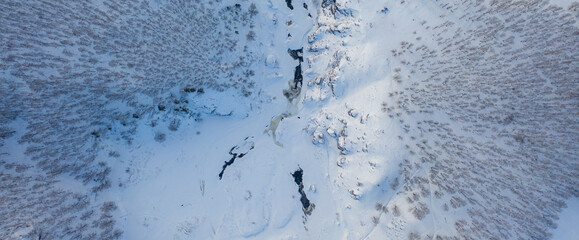 Amazing wild river in frozen forest. Really snowly winter on the north. Aerial panoramic view