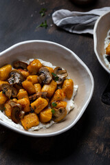 homemade pumpkin gnocchi with mushroom sauce and ricotta