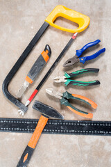 Construction tools set, saw, nippers, pliers, construction mockup on concrete floor during renovation, house construction, template, mockup