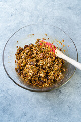 Homemade Baked Granola with Molasses Raisins and Nuts in Glass Bowl.