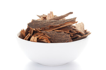 close-up of Organic cinnamon ( Cinnamomum verum) or dalchini on a ceramic white bowl. Pile of Indian Aromatic Spice.
