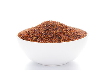 close-up of Organic red-brown small mustard seed (Brassica nigra)  on a ceramic white bowl. Pile of Indian Aromatic Spice.