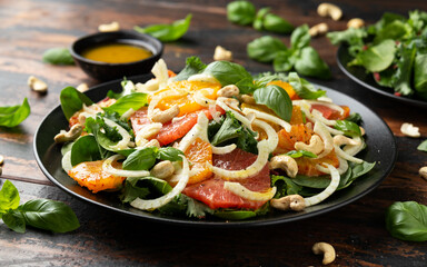 Fresh salad with fennel, orange, grapefruit, spinach and cashew nuts. healthy food.