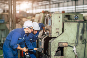 Engineer checking machine maintenance service with team working together teamwork in steel heavy...