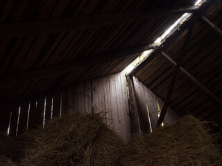 Fototapeta na wymiar Light passing trough boards of an old barn