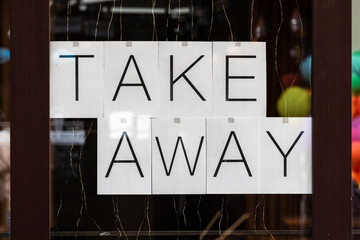 Inscription "take away" on the window of a restaurant during quarantine.
