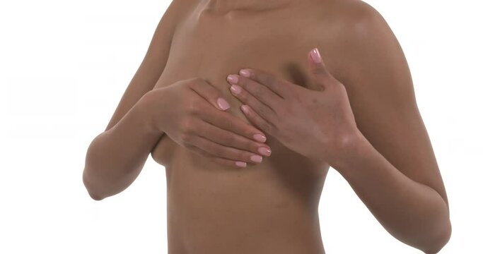 Closeup of breast self exam of unrecognizable african woman. Breast cancer prevention concept. 

