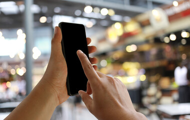 Hand of a businessman hold smartphone and use finger point to empty screen.