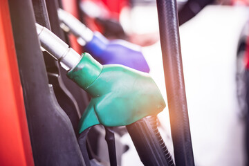 Pumping gas at gas station. Close up of a hand holding fuel nozzle.Colorful Petrol pump filling...
