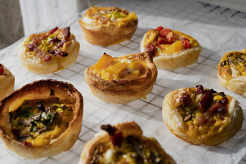 Closeup of savory puff pastries with bacon, peppers, and mushrooms