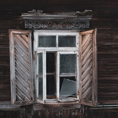 The window of an old wooden house. A window with shutters..