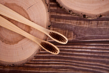 Eco-friendly bamboo teethbrushes on the wooden board. Zero waste