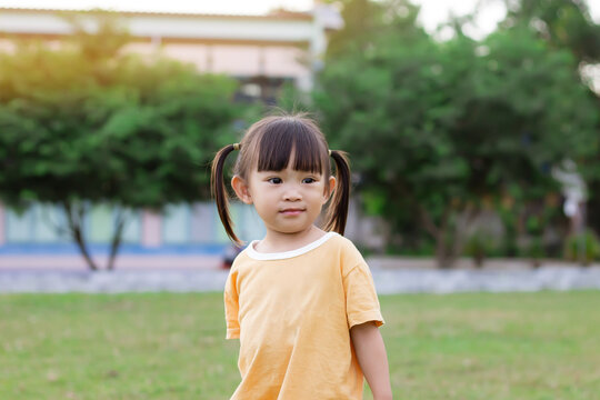 Portrait image of 2-3 years old of toddler baby girl. Happy Asian child playing with the toy at the park playground. Learning and kid concept.