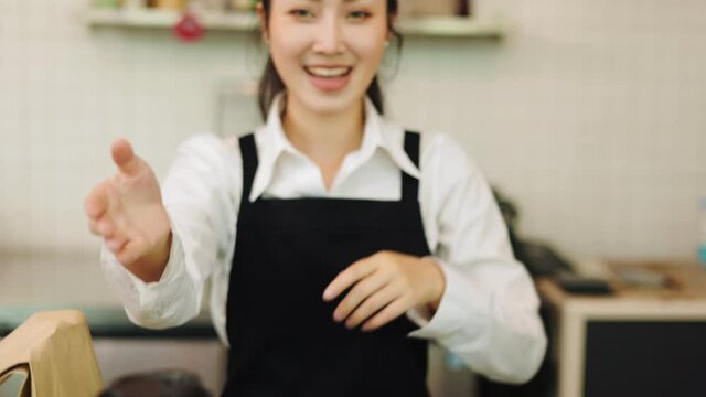 Customer paying with qr code on smartphone screen NFC payment technology at coffee shop.Midsection of female staff showing contactless menu QR code on digital mobile.
