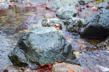 Landscape of stones in a mountain stream in autumn - close-up