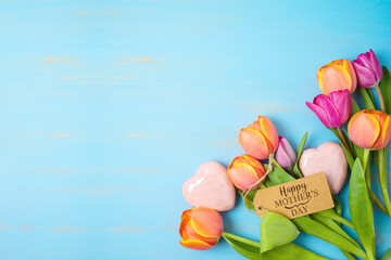 Happy Mother's day concept with beautiful tulip flowers and heart shape on wooden background with...