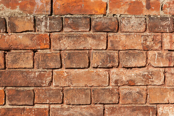 Old brick wall from dark brown and red bricks close-up. Grunge industrial masonry background